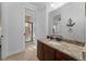 Well-lit bathroom featuring a granite vanity and a walk-in shower at 1041 Castle Pines Ct, Reunion, FL 34747