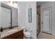 Bathroom with granite vanity, shower with glass door, and beach themed wall decor at 1041 Castle Pines Ct, Reunion, FL 34747