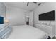 Well-lit bedroom with a large TV, a patterned accent wall and plenty of storage at 1041 Castle Pines Ct, Reunion, FL 34747