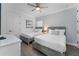 Bedroom with two beds, wood-look floors, and blue-patterned accent wall at 1041 Castle Pines Ct, Reunion, FL 34747
