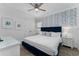 Charming bedroom with patterned wallpaper, plush bedding, and ample natural light at 1041 Castle Pines Ct, Reunion, FL 34747