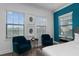 Bright bedroom features stylish blue accents, comfortable seating, and abundant natural light at 1041 Castle Pines Ct, Reunion, FL 34747