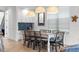 Bright dining area with seating for six and three decorative pendant lights at 1041 Castle Pines Ct, Reunion, FL 34747
