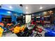 Spacious game room with arcade machines, gaming stations, and stylish decor, perfect for Gathering fun and entertainment at 1041 Castle Pines Ct, Reunion, FL 34747