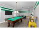Spacious game room with billiard table, seating area, and stylish lighting at 1041 Castle Pines Ct, Reunion, FL 34747