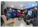 This amazing game room features arcade games, neon lights, and comfortable gaming chairs for ultimate entertainment at 1041 Castle Pines Ct, Reunion, FL 34747