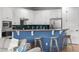 Modern kitchen featuring granite countertops, stainless steel appliances, a breakfast bar, and ample cabinet space at 1041 Castle Pines Ct, Reunion, FL 34747