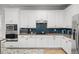 Well-equipped kitchen featuring granite countertops, stainless steel appliances, and white cabinets at 1041 Castle Pines Ct, Reunion, FL 34747