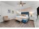 Comfortable primary bedroom with accent wall, seating and modern furnishings at 1041 Castle Pines Ct, Reunion, FL 34747