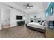 Spacious bedroom with wood floors, a ceiling fan, and plenty of natural light at 1041 Castle Pines Ct, Reunion, FL 34747