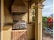 Outdoor kitchen equipped with a stainless steel grill and countertop space, ideal for outdoor cooking and entertaining at 1041 Castle Pines Ct, Reunion, FL 34747