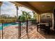 Outdoor patio area with pool, lounge chairs, and a covered dining space at 1041 Castle Pines Ct, Reunion, FL 34747