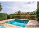 Private in-ground pool with brick surround and mature landscaping for added privacy at 1041 Castle Pines Ct, Reunion, FL 34747
