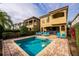 Beautiful in-ground pool with nearby lounge chairs and Mediterranean-style villas at 1041 Castle Pines Ct, Reunion, FL 34747