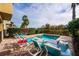 Inviting pool with lounge chairs and outdoor table - perfect for relaxation and entertaining at 1041 Castle Pines Ct, Reunion, FL 34747