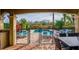 A view of the pool area featuring a fence, lounge chairs, and an outdoor dining area with views of the backyard at 1041 Castle Pines Ct, Reunion, FL 34747