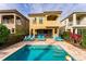 Pool area with Mediterranean-style home, lounge chairs, and lovely landscaping at 1041 Castle Pines Ct, Reunion, FL 34747