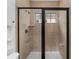 Modern tiled shower featuring sleek black trim and a built-in shelf at 1041 Castle Pines Ct, Reunion, FL 34747