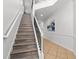 Elegant staircase with wood treads, white risers, and modern black metal railing at 1041 Castle Pines Ct, Reunion, FL 34747