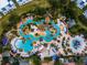 Breathtaking aerial view of the water park showcasing its winding river, colorful umbrellas, and lush landscaping at 1041 Castle Pines Ct, Reunion, FL 34747