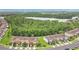 Aerial view of homes with lake and trees in the background of a desirable community at 10656 Savannah Plantation Ct, Orlando, FL 32832