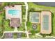 Aerial view of community pool, clubhouse, tennis court, basketball court, and playground at 10656 Savannah Plantation Ct, Orlando, FL 32832