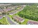 Aerial view of neighborhood with community homes, street access, and nearby woods at 10656 Savannah Plantation Ct, Orlando, FL 32832