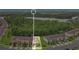 Aerial view of a townhouse property with a lake in the background, surrounded by lush greenery and a peaceful neighborhood at 10656 Savannah Plantation Ct, Orlando, FL 32832