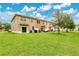 Expansive backyard with well-maintained lawn, ideal for outdoor activities, features patios for lounging and relaxation at 10656 Savannah Plantation Ct, Orlando, FL 32832