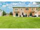 A sprawling backyard with lush green lawn and a patio set, perfect for outdoor relaxation and entertaining at 10656 Savannah Plantation Ct, Orlando, FL 32832