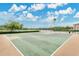 Outdoor basketball court with fenced perimeter and partial views of a nearby lake at 10656 Savannah Plantation Ct, Orlando, FL 32832