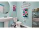 Charming half bathroom featuring pedestal sink and delightful tropical decor at 10656 Savannah Plantation Ct, Orlando, FL 32832