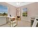 Bedroom with a desk, chair, large windows, and natural light at 10656 Savannah Plantation Ct, Orlando, FL 32832