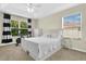 Cozy bedroom with a tray ceiling, ceiling fan and a large bright window at 10656 Savannah Plantation Ct, Orlando, FL 32832