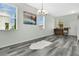 Bright dining room with gray floors, piano, multiple windows, and white walls offering an airy and inviting space at 10656 Savannah Plantation Ct, Orlando, FL 32832