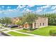 Exterior view of townhomes with lush landscaping, garages, and street parking at 10656 Savannah Plantation Ct, Orlando, FL 32832