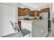 Modern kitchen with stainless steel appliances, granite countertops, wooden cabinets, and a breakfast bar with seating at 10656 Savannah Plantation Ct, Orlando, FL 32832