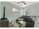 Comfortable living room with a large sectional sofa, accent tables, a stylish rug, and modern decor for a relaxing atmosphere at 10656 Savannah Plantation Ct, Orlando, FL 32832