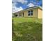 Spacious backyard with lush green grass, a grill, and ample space for outdoor activities at 107 Athabasca Dr, Poinciana, FL 34759