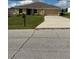 Charming single story home featuring a well-maintained lawn and a two-car garage at 107 Athabasca Dr, Poinciana, FL 34759