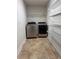 Laundry room with washer, dryer, and wire shelving for storage at 107 Athabasca Dr, Poinciana, FL 34759
