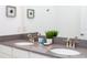 Bathroom featuring double sinks, stylish fixtures, and a granite countertop at 1070 Splash Shot Pl, Davenport, FL 33896
