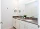 Bright bathroom with double sink vanity, modern fixtures, and neutral tones at 1070 Splash Shot Pl, Davenport, FL 33896