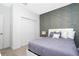 Stylish bedroom featuring a textured accent wall, closet and plush carpet at 1070 Splash Shot Pl, Davenport, FL 33896