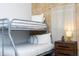 Charming bedroom featuring bunk beds and a unique themed wallpaper at 1070 Splash Shot Pl, Davenport, FL 33896