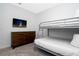 Well-appointed bedroom with bunk beds, TV, and a sleek modern dresser at 1070 Splash Shot Pl, Davenport, FL 33896