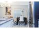 Dining room with seating for six, modern art, and a view into the living room at 1070 Splash Shot Pl, Davenport, FL 33896