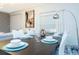 Elegant dining room features a modern table setting and views into the living room at 1070 Splash Shot Pl, Davenport, FL 33896