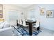Formal dining room with seating for six, large windows, and modern decor at 1070 Splash Shot Pl, Davenport, FL 33896