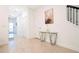 Bright hallway with modern table, staircase, and contemporary artwork at 1070 Splash Shot Pl, Davenport, FL 33896